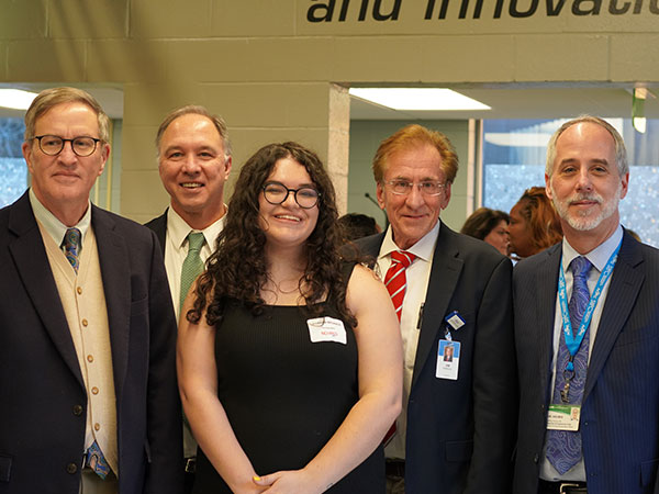 Harper Nichols (center) and exhibit attendees. 