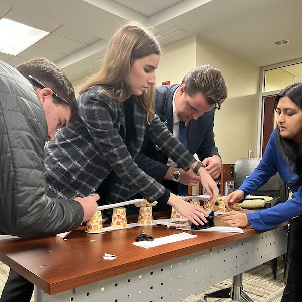 HA 631 class uses tape and scissors to build the paper-based bridge