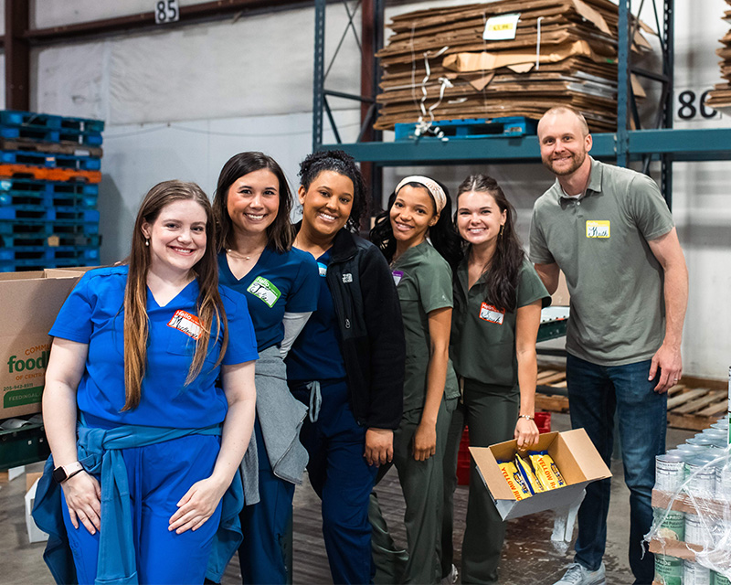Student volunteers in a food bank warehouse,