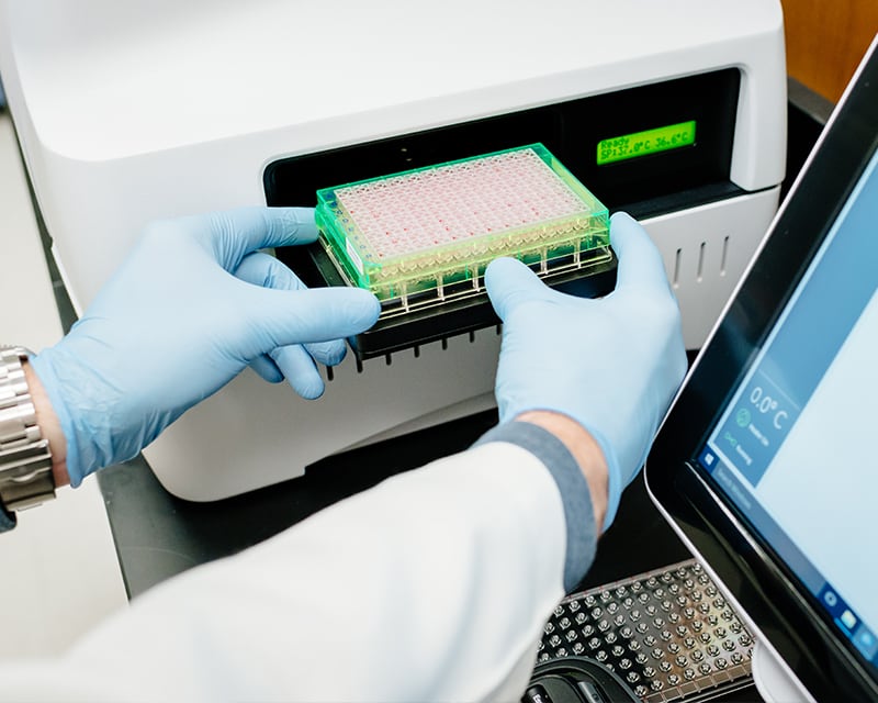 Student working with lab equipment in the Department of Nutrition Sciences.