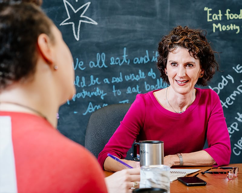 Dr. Beth Kitchin working with a student to implement health initiatives.