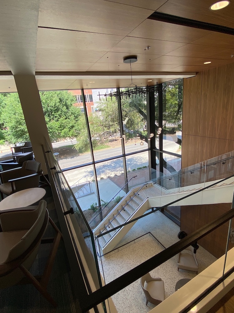 View from 2nd floor. You see the open stairwell, the glass walls facing University Boulevard, and the gorgeous chandelier.