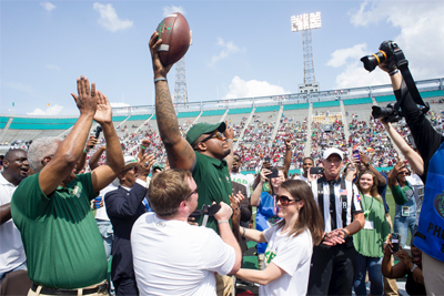 Natalie Shannon and Tim Alexander walking across Legion field.