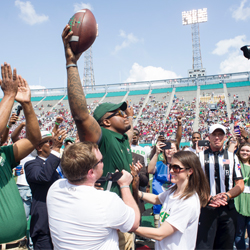 Natalie Shannon and Tim Alexander walking across Legion field.