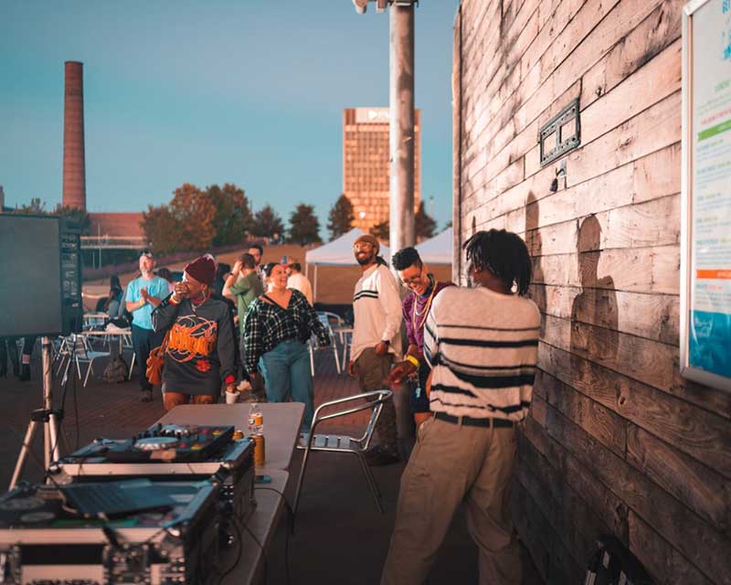 Students having a party outside at sundown.