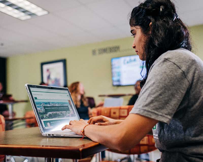 Student using laptop in class.