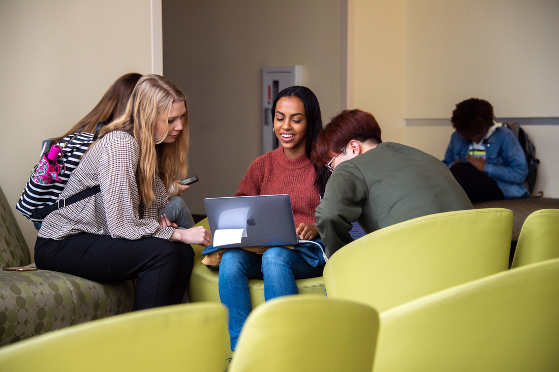 UAB students gathered around a computer