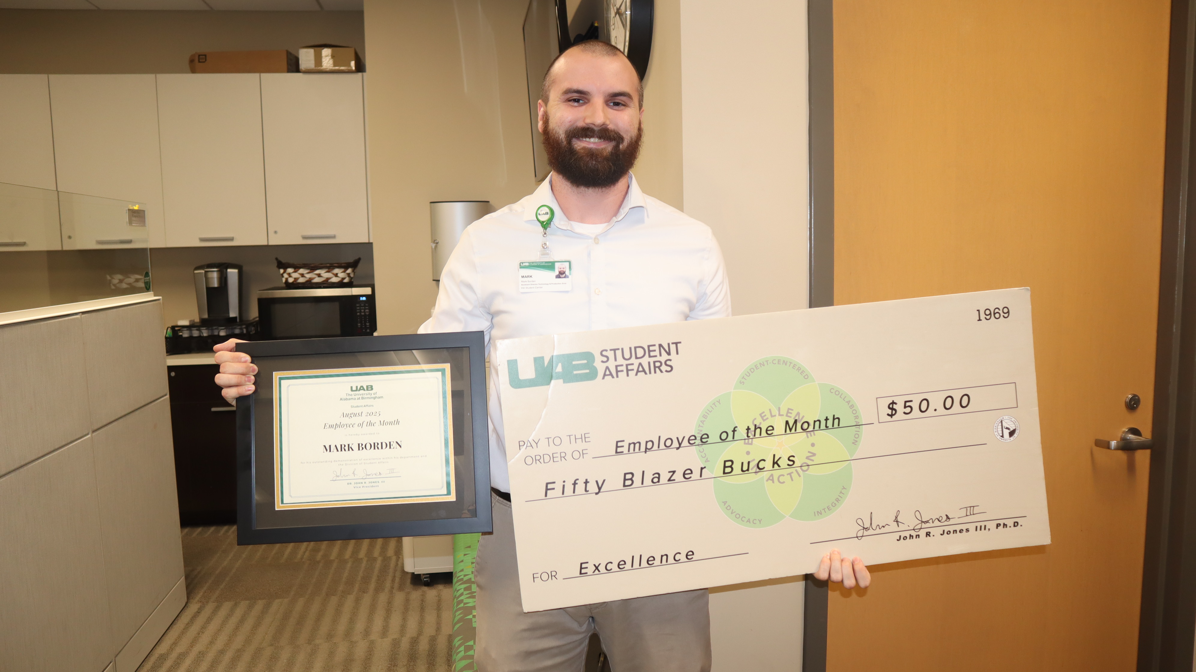 Mark Borden with his August Employee of the Month frame and Blazer bucks check