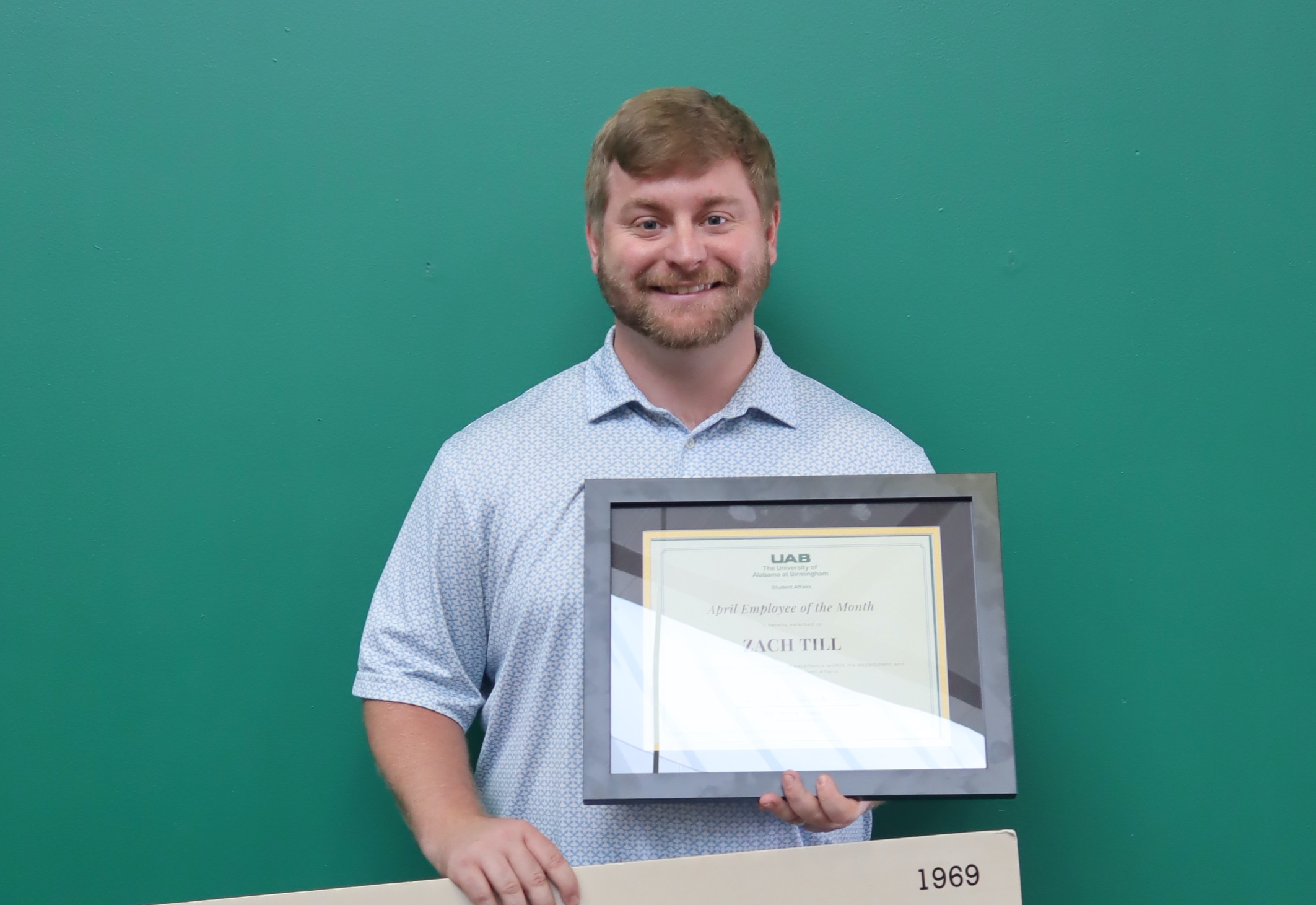 Zach Till with the April Employee of the Month Award
