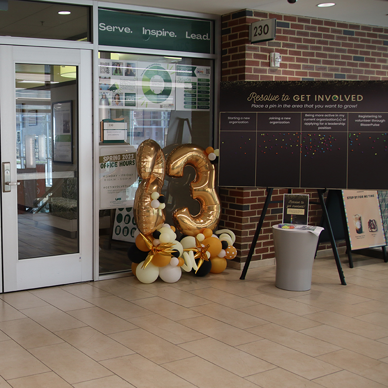 Sign saying "Resolved to Get Involved" located outside of the Student Involvement & Leadership office suite 