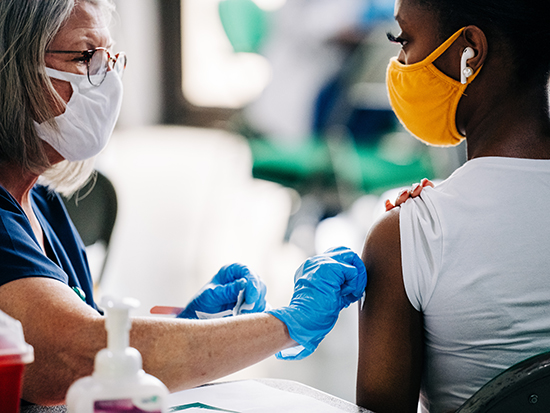 student receiving a COVID-19 vaccination