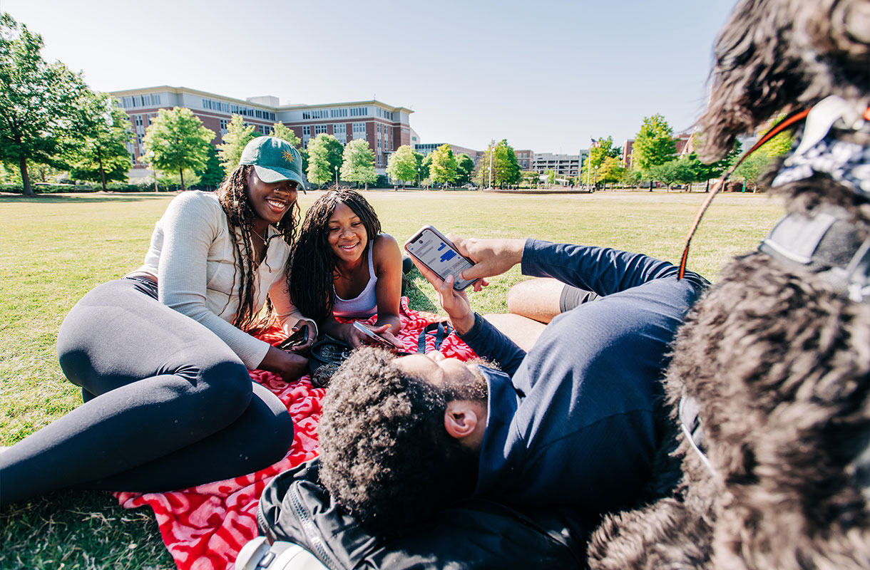 Students relaxing on the campus green