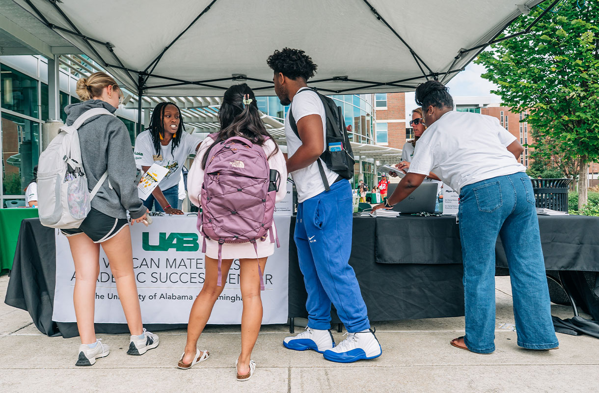 Students standing at the UAB Vulcan Materials table