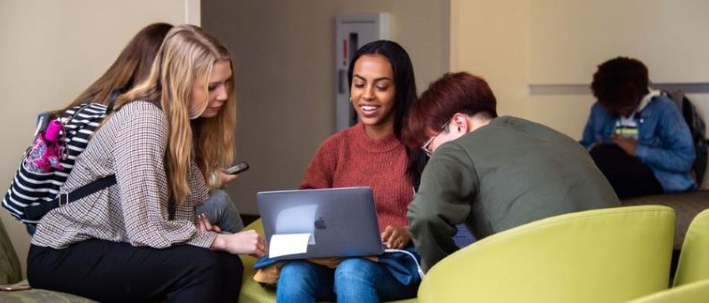 Group of students socializing around a table