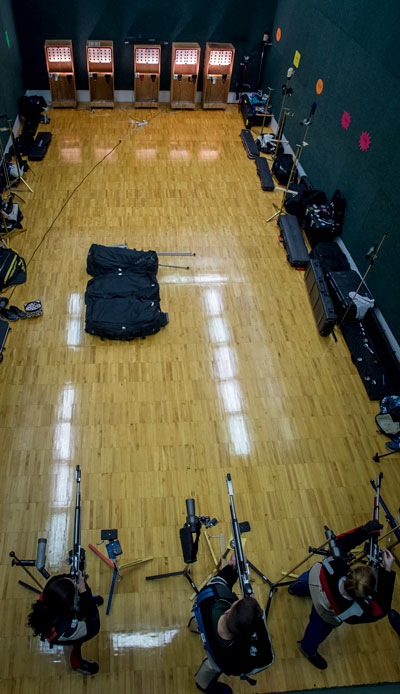 Overhead photo of rifle athletes firing at targets at campus practice facility