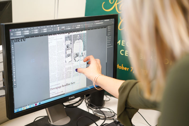 Photo of Chandler Jones designing newspaper page on computer screen