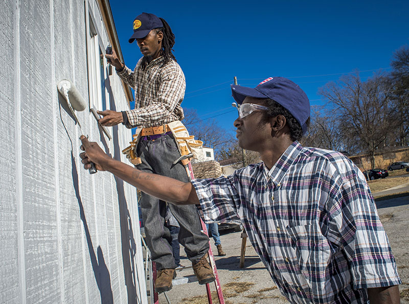 Carpentry project students working on a building