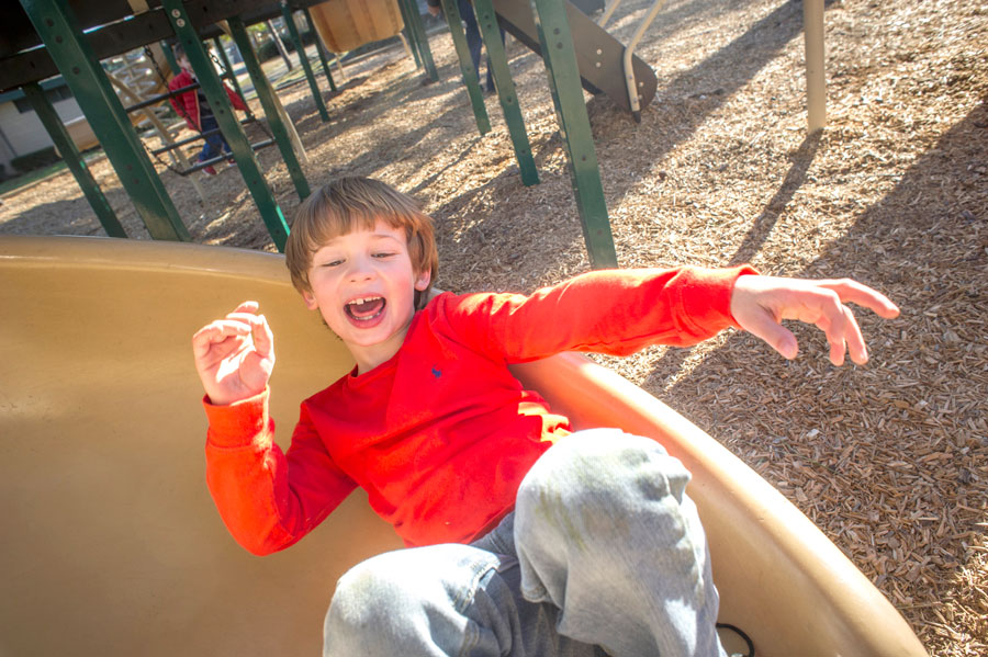 Photo of little boy on slide