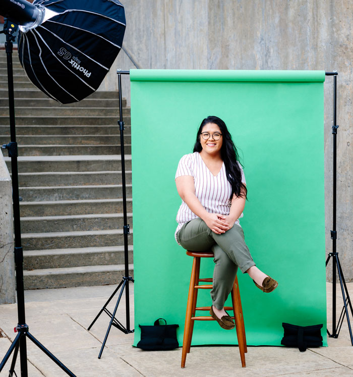 Photo of Leahgrace Simons against green backdrop and photo lights