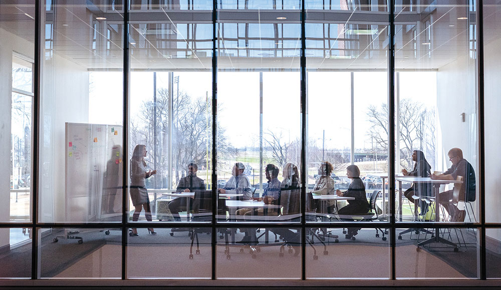 Photo of people meeting in glass-walled room at Bill L. Harbert Institute for Innovation and Entrepreneurship