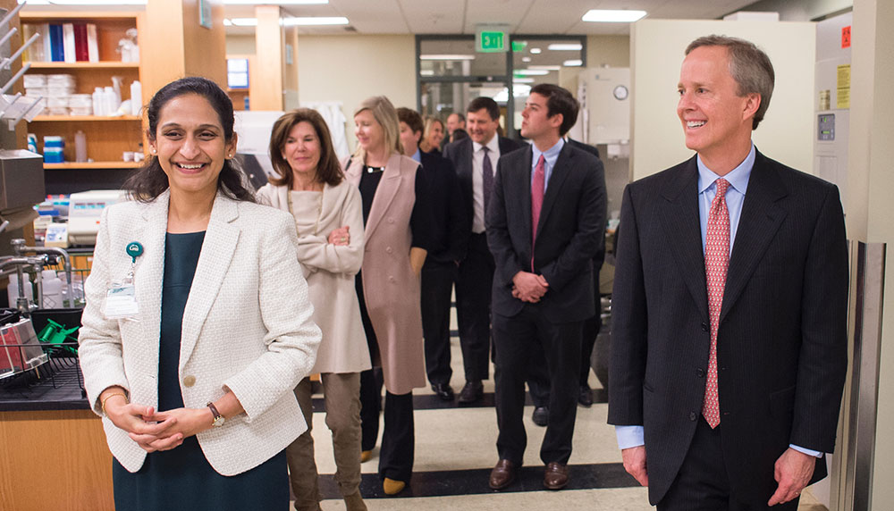 Photo of Lalita Shevde-Samant showing O'Neal visitors her lab