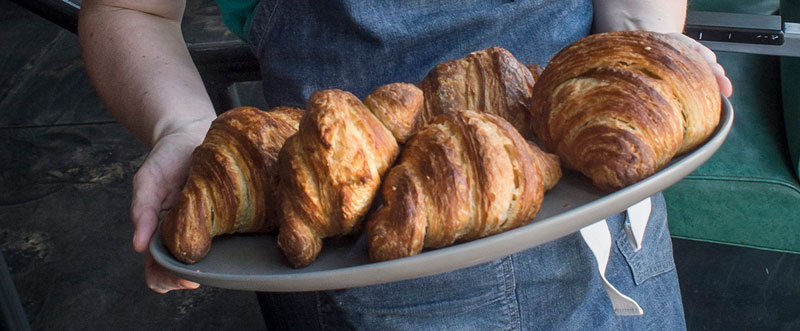 Closeup photo of croissants held by Kristen Farmer Hall