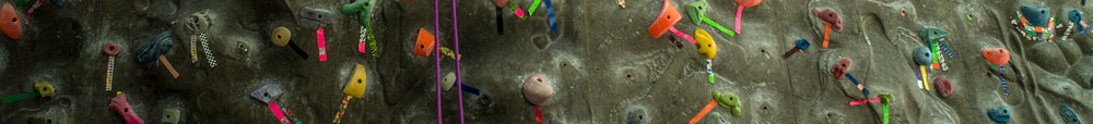 Closeup photo of multicolored holds on climbing wall