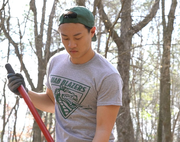 Photo of student working with hoe or rake at Red Mountain Park