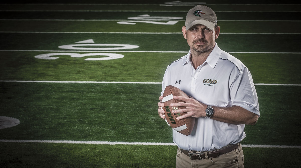 Photo of Bill Clark holding ball on new practice field