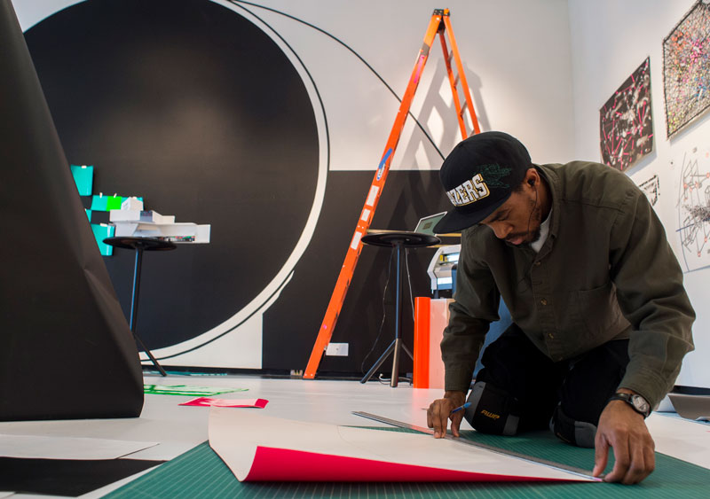 Photo of student working to build Angel's art installation