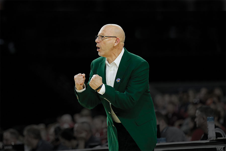 Photo of Coach Randy Norton cheering on team at Bartow Arena game