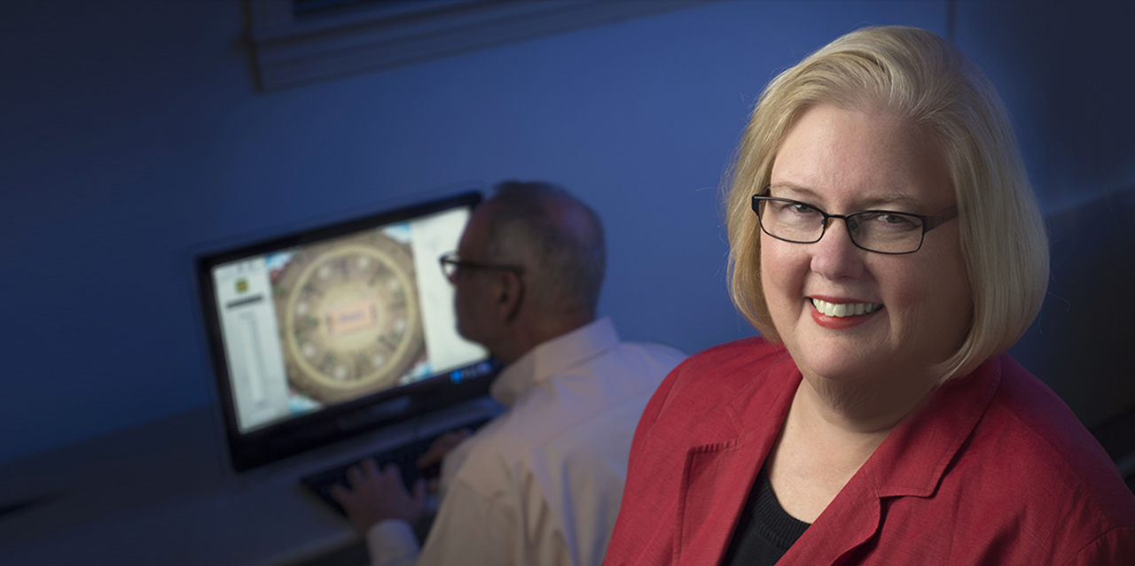 Karlene Ball with patient using brain-training software in background