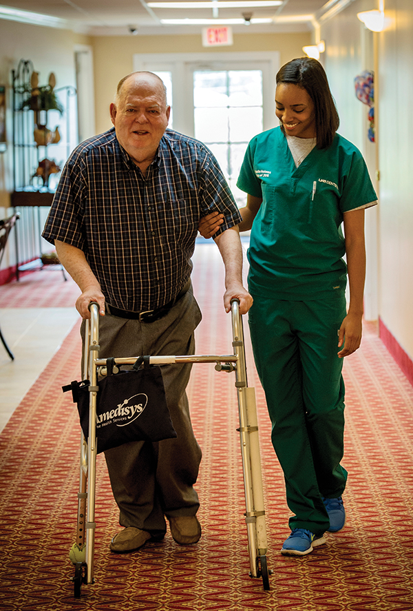 Dental student D'Andrea Nekelle Holmes walks with a Fair Haven resident.