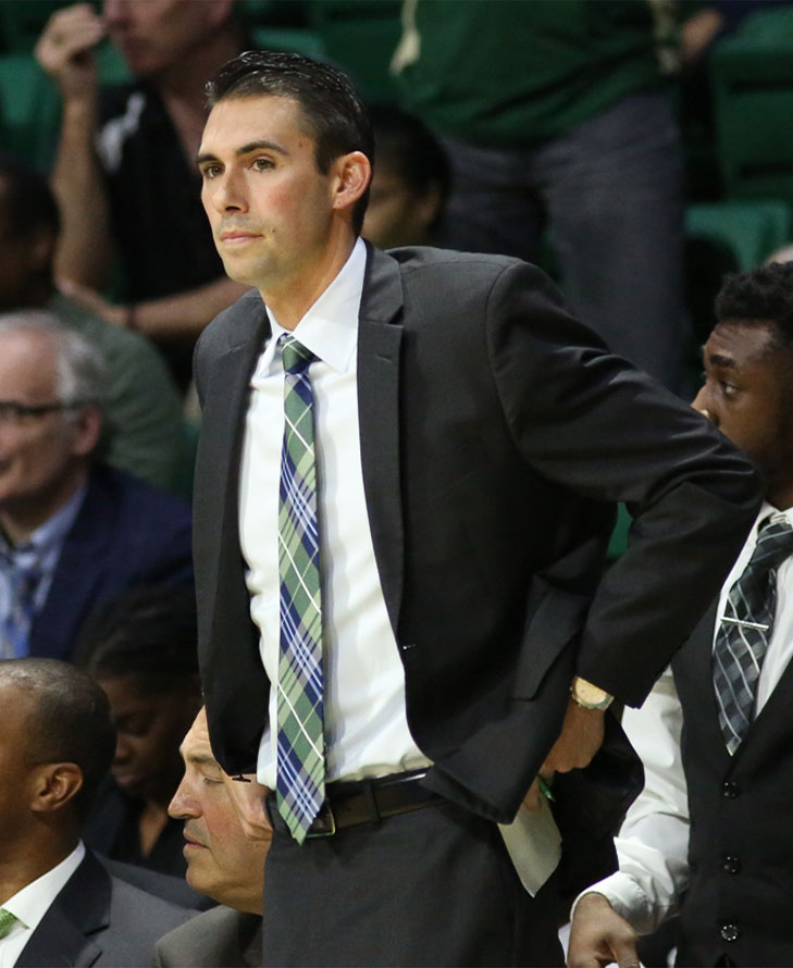 Photo of Rob Ehsan watching court during basketball game