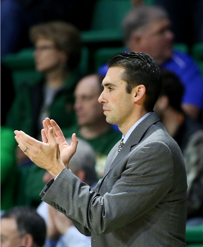 Photo of Rob Ehsan clapping during basketball game