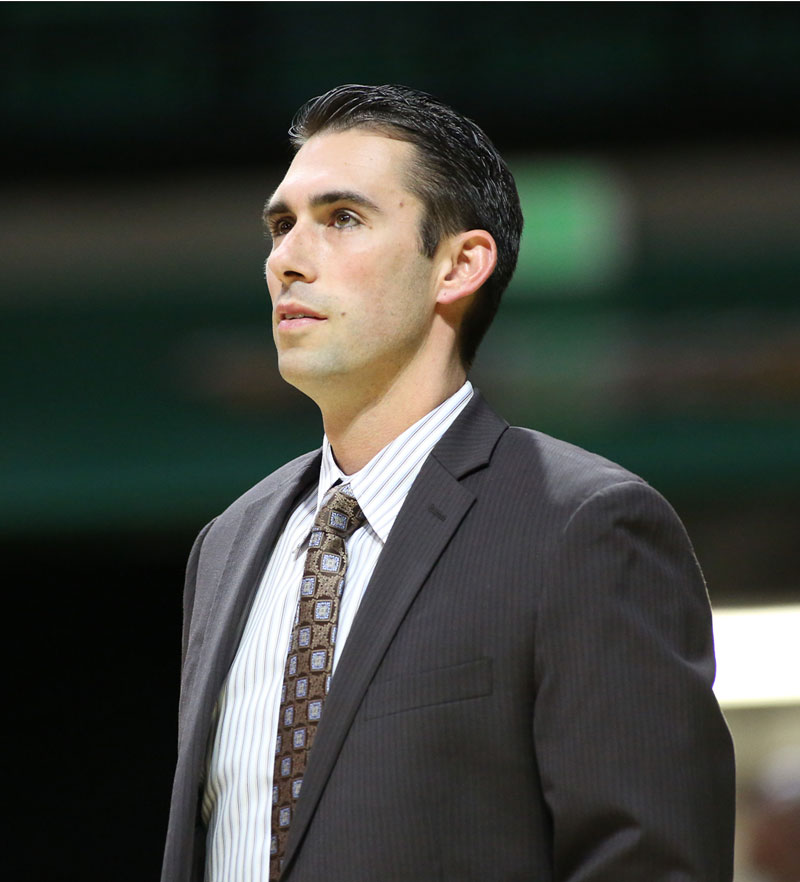 Photo of Rob Ehsan watching court during basketball game