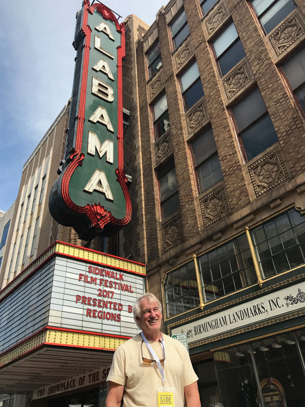 Photo of George Hardy in front of Birmingham's Alabama Theatre