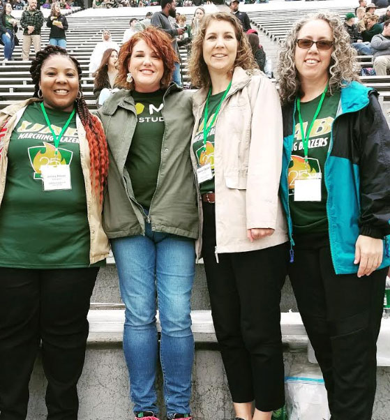 Photo of color guard alumni in stands at Legion Field