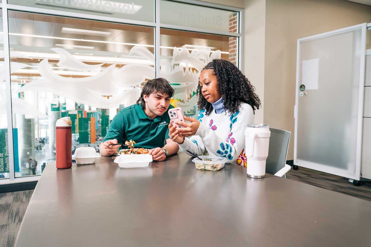 Hollingsworth and Testman eat lunch in a campus office.
