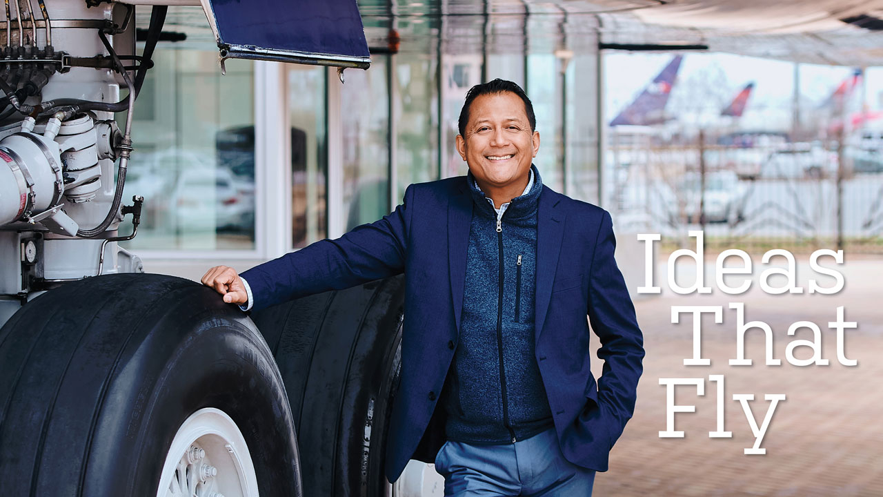 Photo of August Oo standing next to wheel of vintage Delta plane; headline: Ideas That Fly