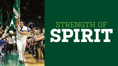 Photo of cheerleader Jamie Thrasher carrying UAB flag through Bartow Arena crowd; headline: Strength of Spirit